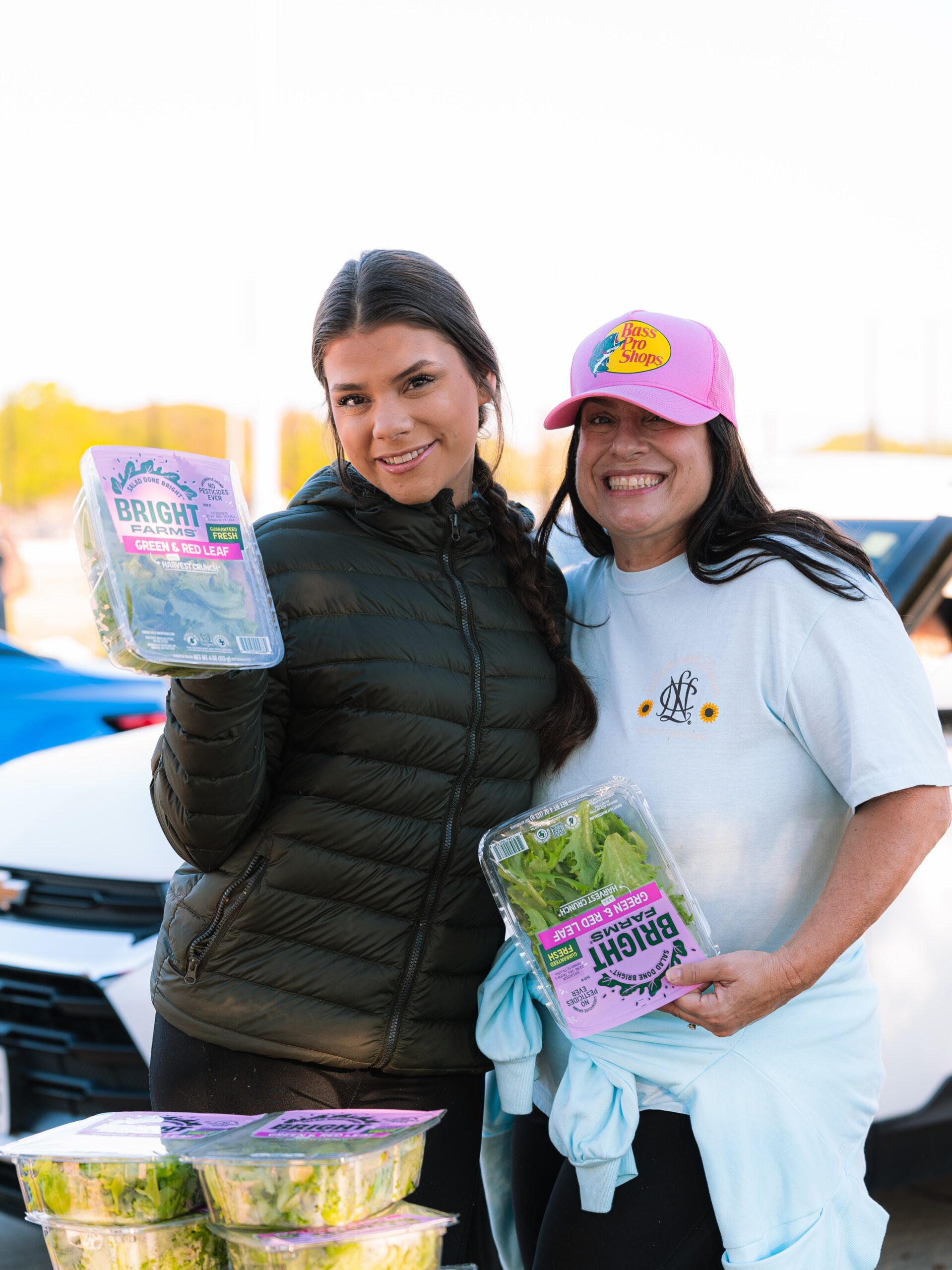 Two smiling volunteers serving their neighbors