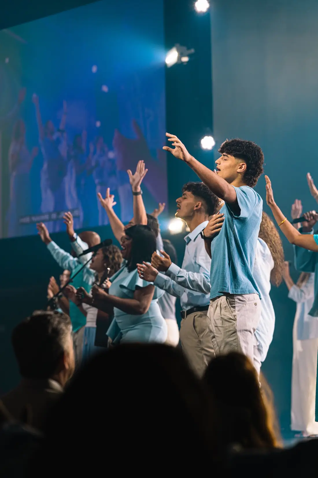 People raising their hands during a church gathering