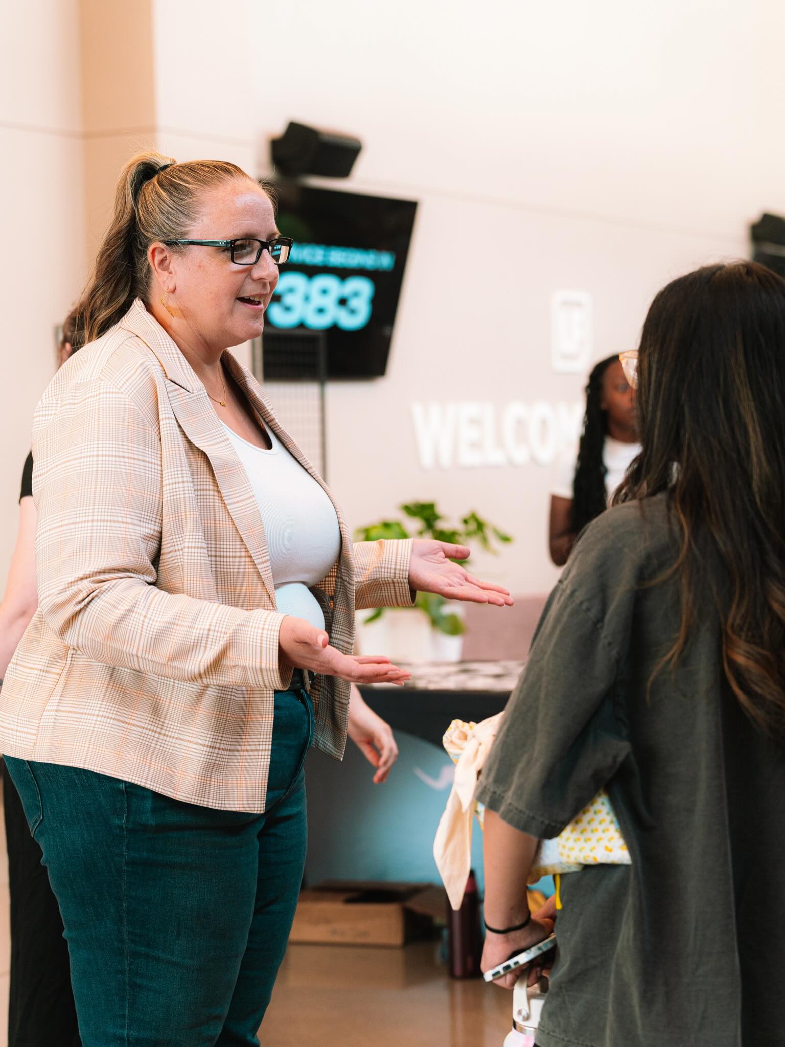 An attendee talks with others in the church lobby.