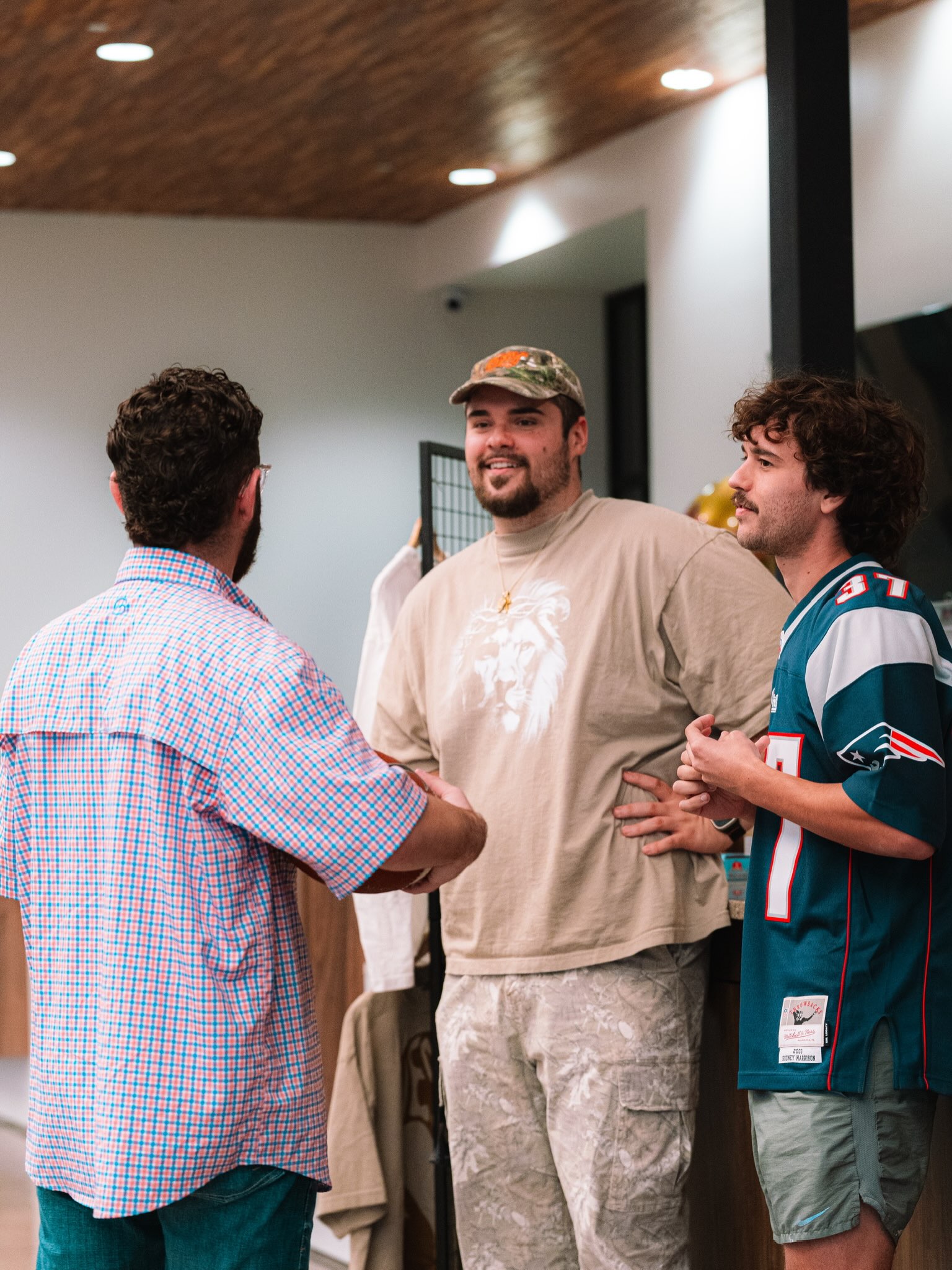 Three young adults talk together in the lobby.